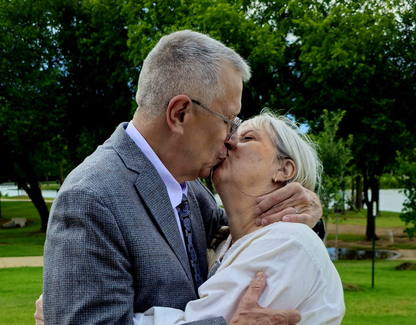 Kristin Milan and Neil sharing a kiss on their wedding day.